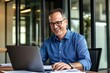 © MiraCle72 - Middle-aged professional engaged in productive work with laptop in a bright office