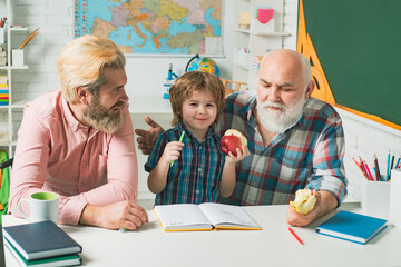 Fototapete - Father and son with grandfather learning to write and read at school. Men generation. Fathers day.