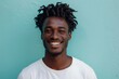 © Markus Schröder - Portrait of a smiling afro-american man in his 20s donning a trendy cropped top isolated in pastel blue background