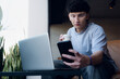 © SETO fotografias - man checking incoming call on mobile phone