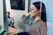© BullRun - Ethnic woman standing near flip chart in workplace