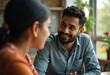 © Dexon Studios - A smiling man and woman share an intimate moment in a cafe setting. Their connection is evident in their gazes and smiles. Soft lighting enhances the mood.