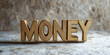 © Steven - Wooden text 'MONEY' against light backdrop. Business, finance and profit concept
