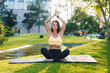 © Strelciuc - A Woman Engaged in Practicing a Yoga Pose Within a Serene and Tranquil Outdoor Setting