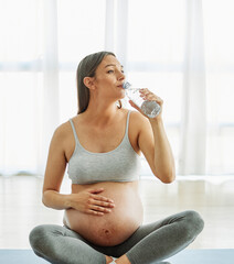 Wall Mural - woman pregnant mother pregnancy female exercise sport fitness belly healthy maternity motherhood health yoga young dumbbell weight laptop computer online water drink bottle hydrate