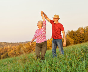 Wall Mural - woman man outdoor senior couple happy lifestyle retirement together smiling love dancing nature matu