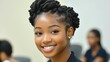 © imagineRbc - A woman with a big smile on her face. She has a black hairstyle and is wearing a gold earring