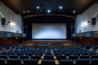 © Alena - A large auditorium with blue seats and a projector screen for presentations, meetings, or lectures
