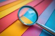 © Ева Поликарпова - A close-up image of a magnifying glass sitting on a vibrant background