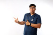 © ArvStd - Professional doctor, male nurse or physician in scrubs inform patients,looking camera and pointing sideways showing clinic banner.Surprise and amazed gesture
