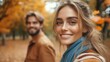 © imagineRbc - A woman and a man are smiling at the camera in a park. The woman is wearing a blue scarf and the man is wearing a brown jacket. Scene is happy and lighthearted