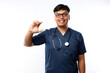 © ArvStd - Doctor man wearing medical uniform over blue background smiling and confident gesturing with hand doing small size sign with fingers looking and the camera. Measure concept
