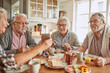 © Marko Geber - Senior friends enjoying breakfast together in a cozy kitchen