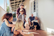 © Marko Geber - Happy multigenerational family playing soccer on home porch