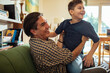 © Marko Geber - Father playing and bonding with son at home