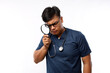 © ArvStd - Nurse holding a magnifying glass on a white background