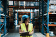 © Davor - Female warehouse worker inspecting inventory with clipboard