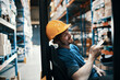© Davor - Warehouse worker operating forklift in storage aisle