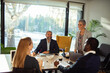 © Geber86 - Team collaboration in modern office space with diverse professionals using laptops and discussing project