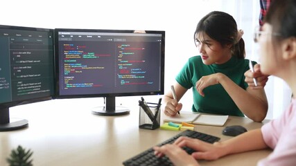 Slow motion back end software developer engineer for computer programming working together on debugging writing computing code, solving complex algorithms display on monitor in office. Burgeoning