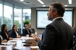 © Milos - A professional man passionately discusses ideas during a business meeting in a sleek conference room, with attentive colleagues focused on the insights and strategies presented.