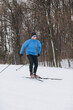 © dsheremeta - oung Caucasian male skier athlete skiing downhill on a cross-country trail in winter