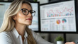 © stock1 - A strong female boss conducting a hybrid strategy session, digital charts visible on screens