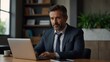 © bedamanusia - Businessman Working on Laptop in Modern Office