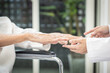 © Satjawat - Senior stretching her arms,doctor examines the patient's hands for any tremors,signs of thyroid -related issues or diseases of  Hyperthyroidism,Stroke,Parkinson's disease,health care,medical concept