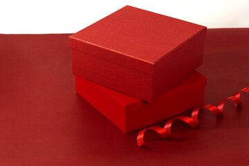 Red Gift Box With Ribbon On Vibrant Red Background