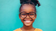 © mahamad - A headshot portrait of a happy mixed-race girl wearing glasses.