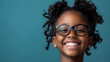 © mahamad - A headshot portrait of a happy mixed-race girl wearing glasses.