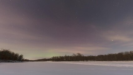 Wall Mural - Timelapse shot of Aurora pulsing over a winter lake in northern Wisconsin of USA during dawn.