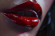 © EliteStock - Close-up of glossy, bold red lips reflecting light, showcasing a striking beauty and allure.
