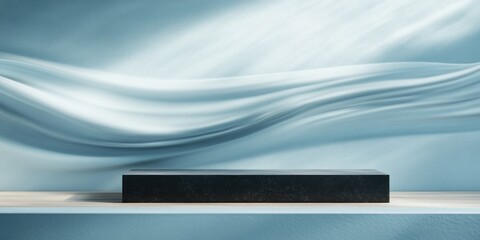Poster - A sleek black object on a light wooden shelf against a soft blue background with flowing textures.