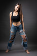 © Mountains Hunter - A beautiful brunette poses in the studio wearing a top and jeans.