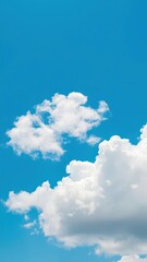 Wall Mural - Vibrant clear blue sky with fluffy white clouds on a sunny day, clear