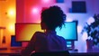 © Andrew - Night Shift: A young woman focused on her work at night, illuminated by colorful monitor lights. A captivating image of dedication and late-night productivity.
