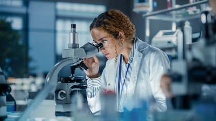 Aufkleber - Portrait of a Multiethnic Student Working on a Research Project in College. Medical Research Scientist Looking at Biological Samples Under a Microscope in an Applied Science Laboratory