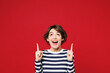 © ViDi Studio - Young surprised shocked happy woman she wear blue striped sweatshirt casual clothes point index finger overhead on empty area mockup isolated on plain red background studio portrait Lifestyle concept