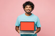 © ViDi Studio - Young IT Indian man he wear blue t-shirt casual clothes hold use work on laptop pc computer with blank screen workspace area isolated on plain pastel light pink background studio. Lifestyle concept.