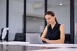 © NVB Stocker - Business woman busy working on laptop. successful Beautiful businesswoman in modern office with laptop, success happy pose. Work from home and social distancing concept