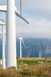 © yaqui_villegas - A dynamic image showing a cluster of wind turbines against a rugged mountain backdrop, highlighting the integration of renewable energy solutions in wild landscapes in Navarra Spain
