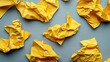 © VRVisionary - Crumpled yellow paper clippings scattered on a gray background, emphasizing recycling and reuse challenges, creative concept, environmental issues, sustainability, texture.