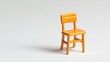 © GenZGraphics - Miniature orange school chair on white background symbolizing education and childhood creativity