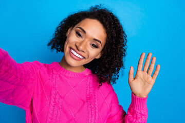 Poster - Photo of nice young girl make selfie arm wave wear pink sweater isolated on blue color background