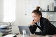 © Fahng - young asian woman working at her desk, writing notes. Businesswoman at her workplace.