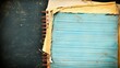 © SUCCESS HOLDINGS - A close-up of a spiral-bound notebook with aged edges and a faded blue page, set against a scratched dark surface, conveying a vintage and rustic charm