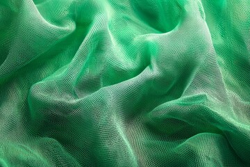 Close-up of green mesh fabric, with waves and folds, against a vibrant green background. 