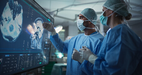 Aufkleber - Caucasian Male and Female Surgeons Analyze Brain Scans on a Digital Monitor, Planning Surgical Strategy in a High-tech Operating Room. Colleagues Working Together, Preparing for Surgery